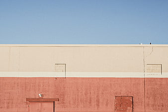 Minimalist Building Facade with Blue Sky and Terracotta Wall