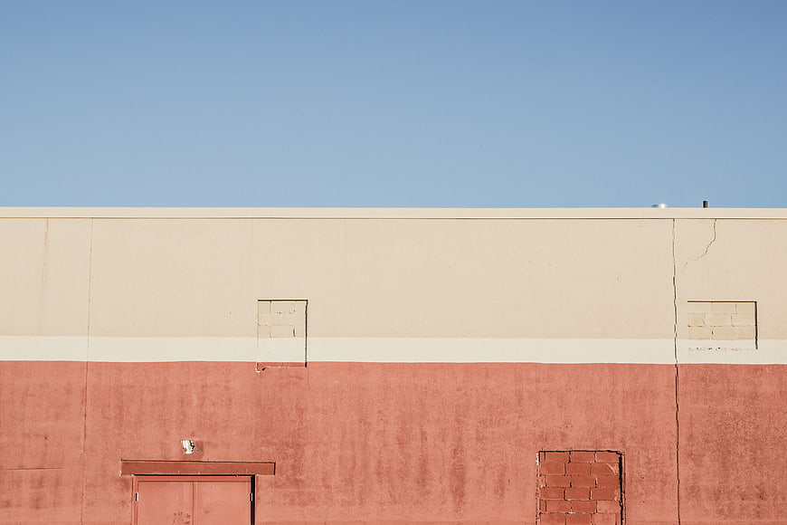 Minimalist Building Facade with Blue Sky and Terracotta Wall