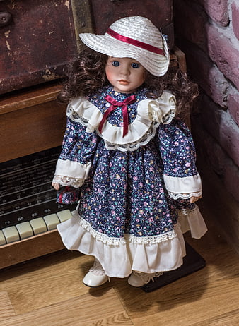 Vintage Doll in Floral Dress and Straw Hat