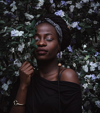 Serene Black Woman Smelling White and Purple Gardenia Flowers