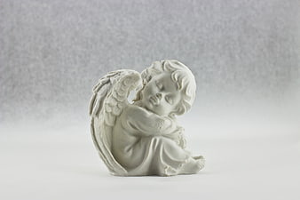 White Sleeping Angel Statue on Gray Background