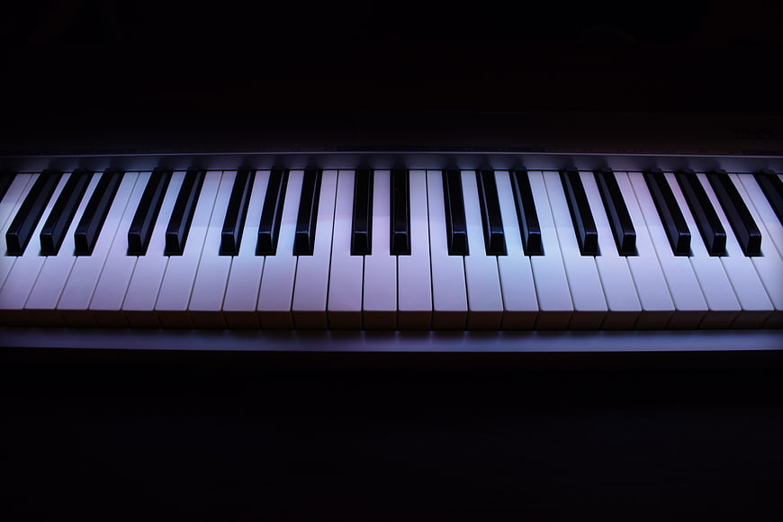 Illuminated Piano Keys Against Dark Background