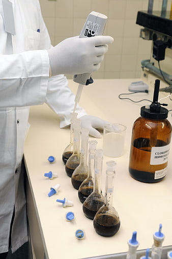 Scientist Using Pipette In Chemistry Laboratory
