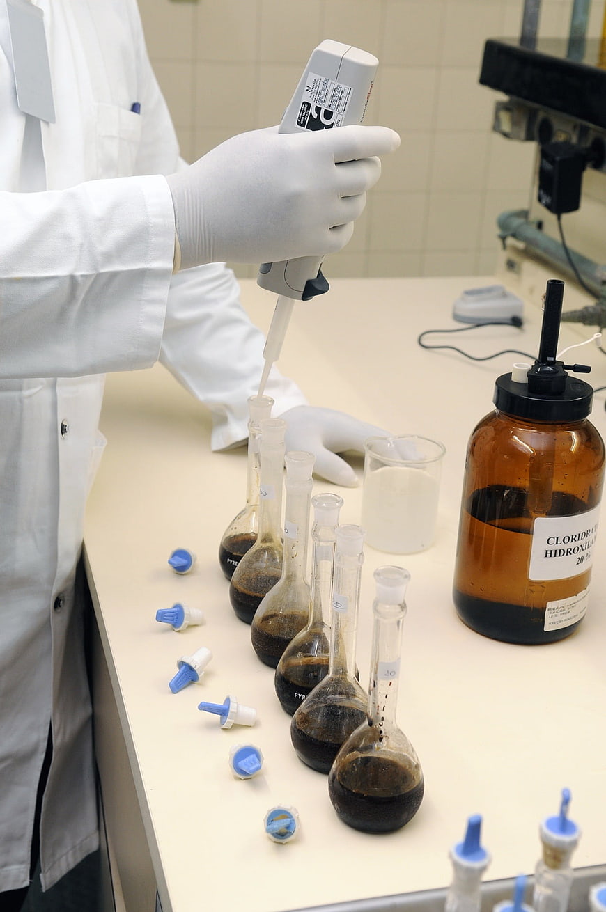 Scientist Using Pipette In Chemistry Laboratory
