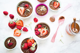Overhead view of chocolate pudding with strawberries and raspberries