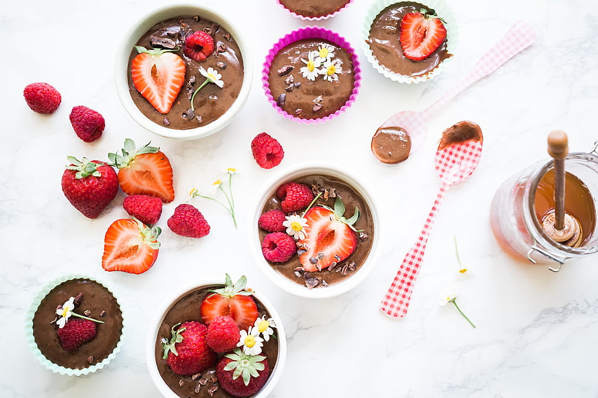 Overhead view of chocolate pudding with strawberries and raspberries