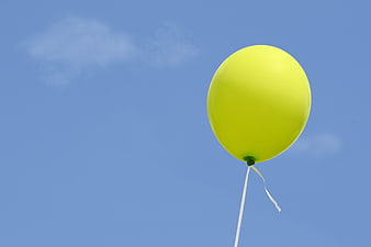 Yellow Balloon Floating Against Blue Sky