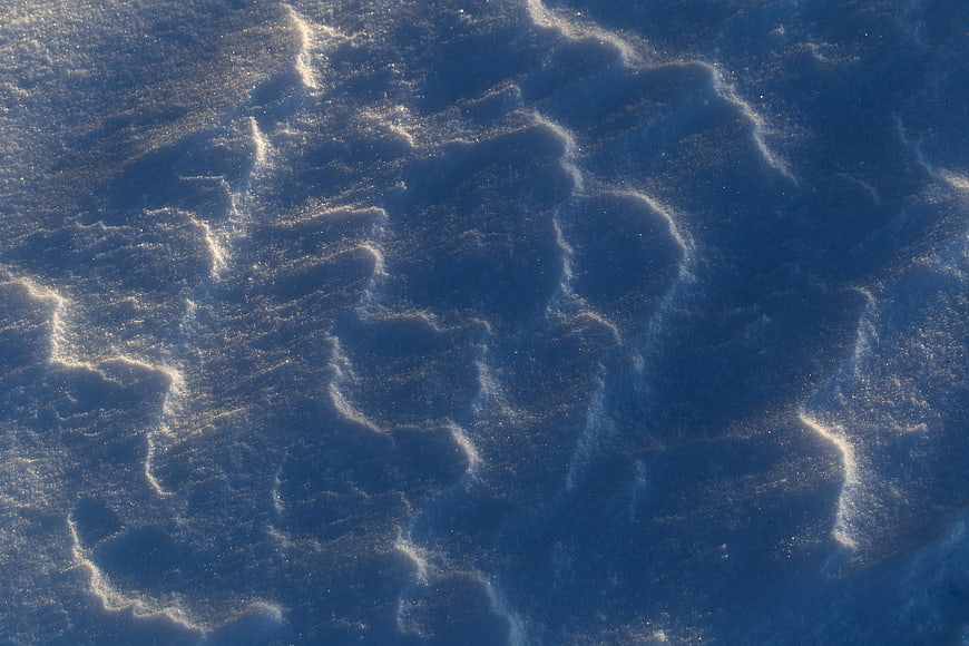 Aerial View of Wind-Sculpted Snow Texture with Shadows