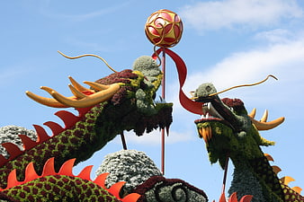Two Floral Dragon Heads Chasing a Golden Orb Sculpture