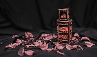 Ornate Decorative Box with Dried Rose Petals on Black Fabric