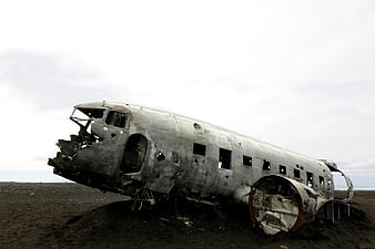 Weathered Airplane Wreckage on Dark Beach in Iceland