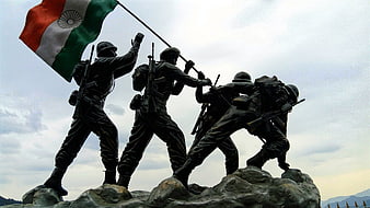Indian Army Soldiers Statue Raising Flag on Rocky Peak
