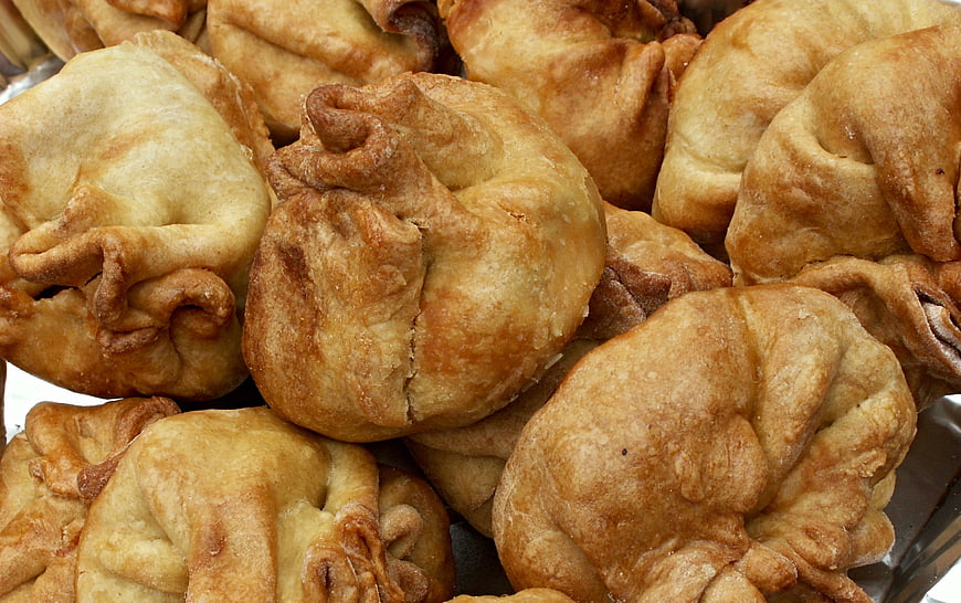 Close-up of golden fried pastries piled on a tray