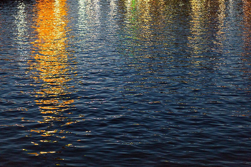 Golden Sunset Reflections on Rippling Water Surface