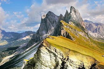 Dramatic Dolomites Mountain Ridge with Golden Grass