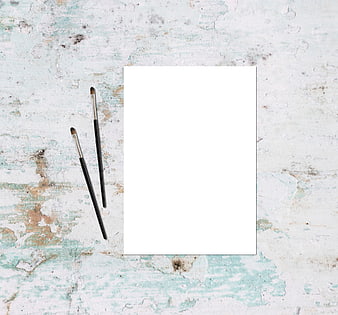 Blank Paper and Paintbrushes on Textured Rustic Background