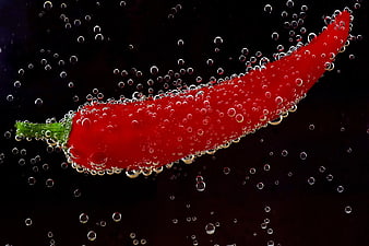 Red Chili Pepper Submerged in Water with Bubbles