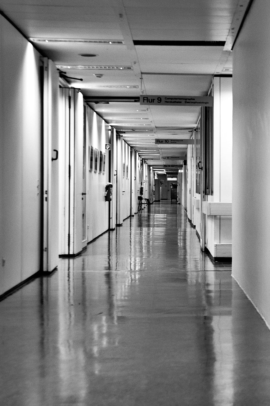 Black and white photo of empty hospital corridor