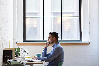 Thoughtful Man Working at Desk in Modern Office