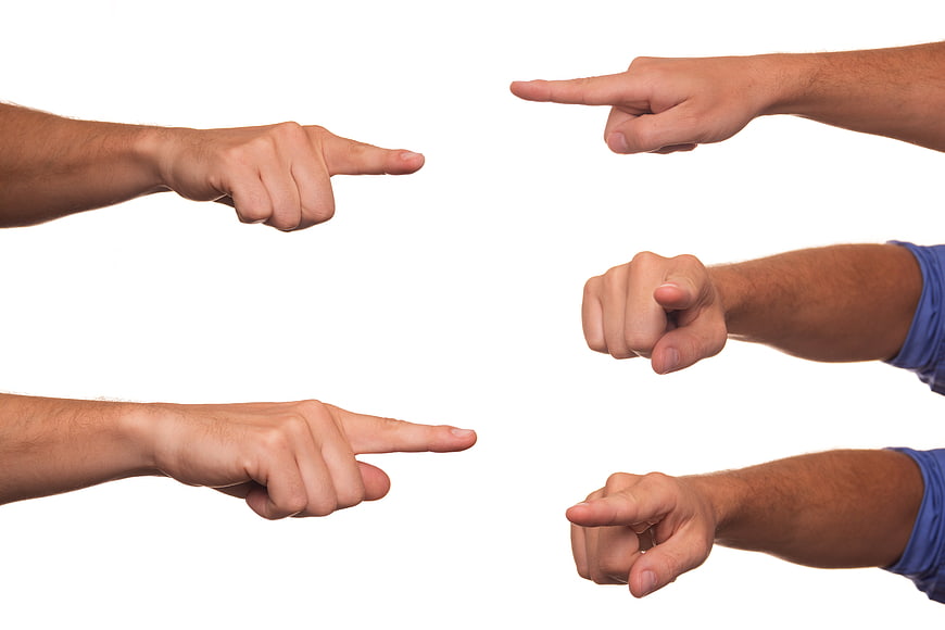 Multiple Hands Pointing Inward To Central White Space