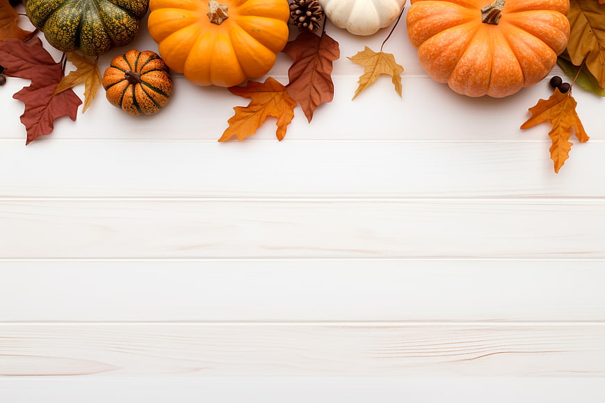 Autumn pumpkins and leaves on white wood background with copyspace