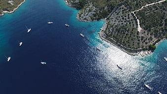 Aerial View of Turquoise Bay with Sailboats