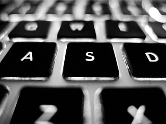 Close-up of black laptop keyboard keys in black and white