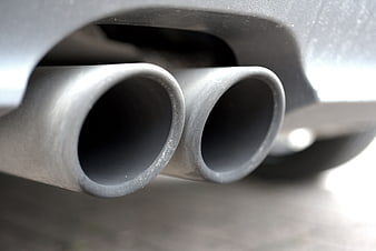 Close-up of dual car exhaust pipes with shallow depth of field