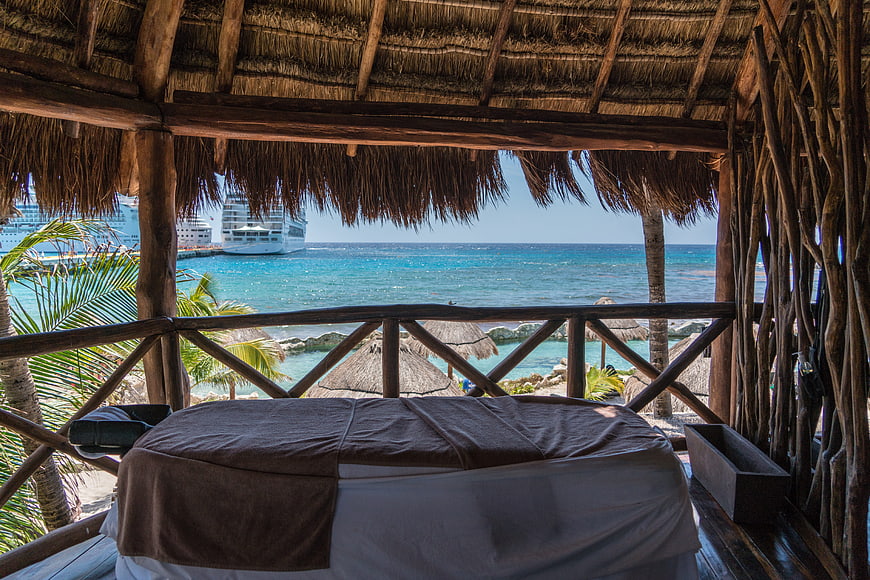Tropical Spa Massage Table With Ocean View And Cruise Ships