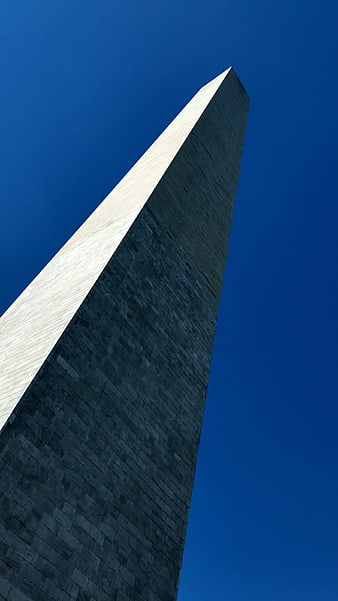 Low angle view of Washington Monument against blue sky