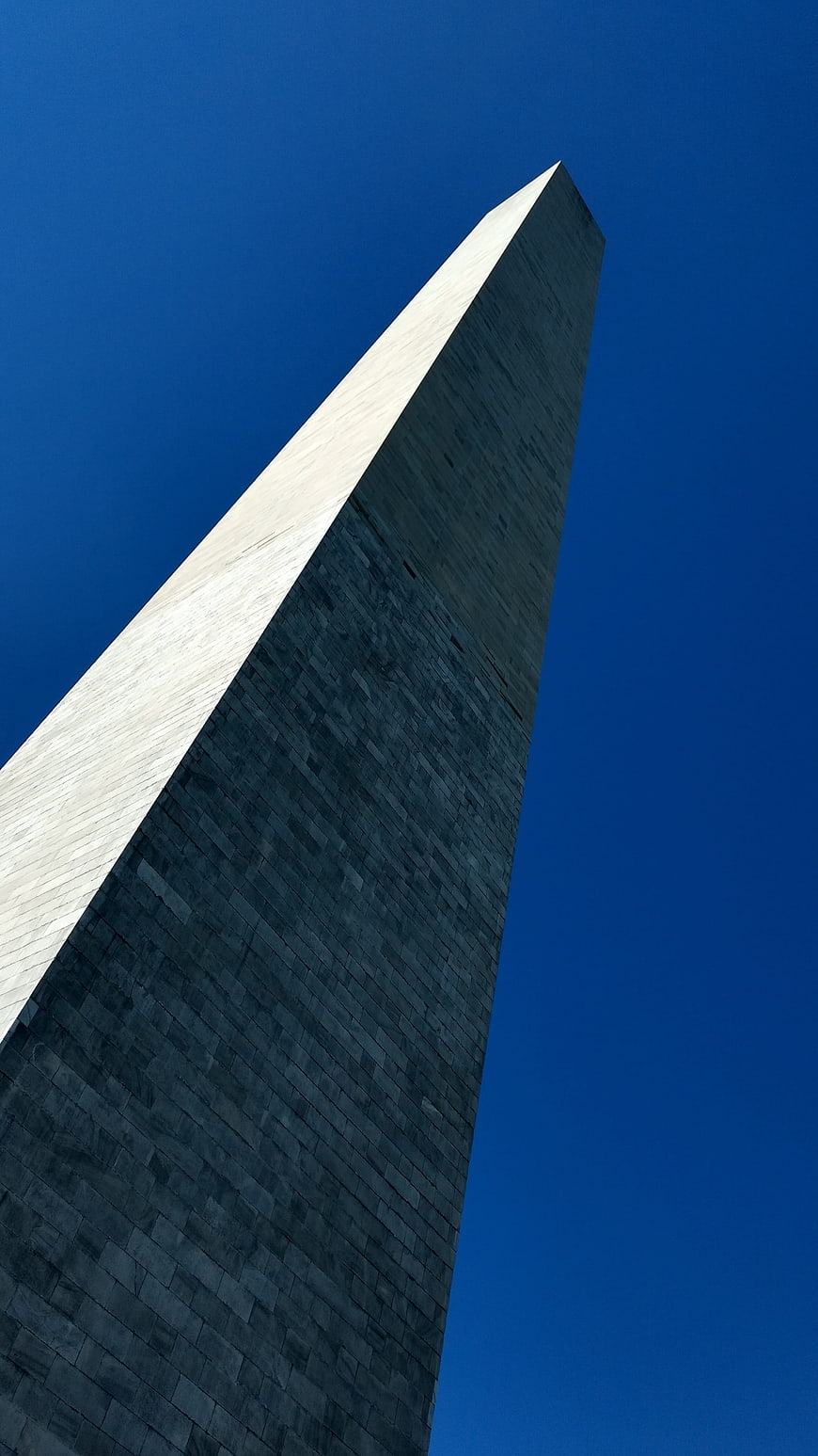 Low angle view of Washington Monument against blue sky