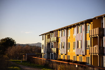 Modern Yellow Apartment Building at Sunset