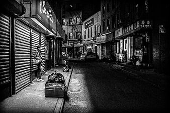 Woman waiting on dark urban street at night