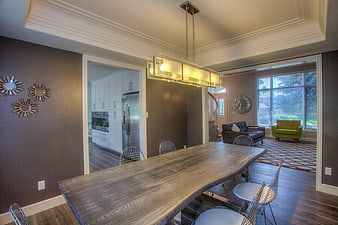 Modern dining room with live edge table and open kitchen