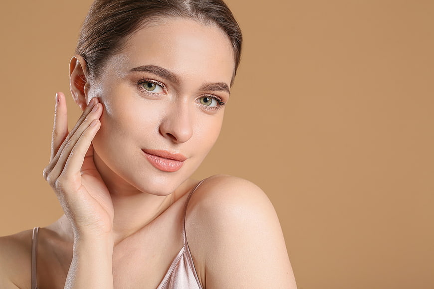 Beautiful Woman Touching Face with Natural Skin