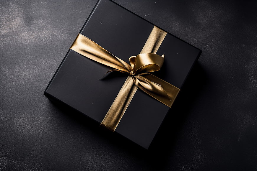 Black Gift Box with Gold Ribbon on Dark Background