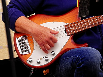 Close-up of musician playing electric bass guitar