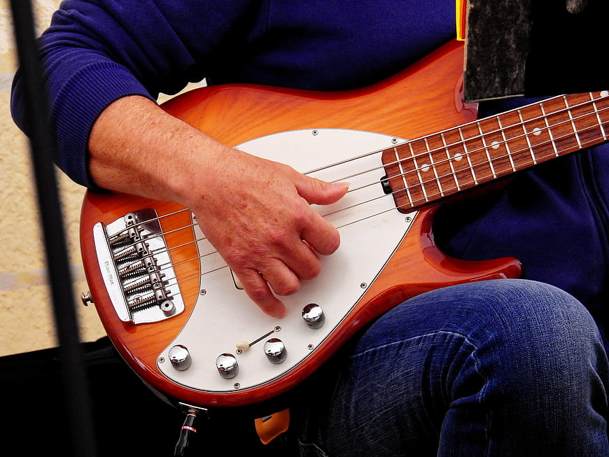 Close-up of musician playing electric bass guitar