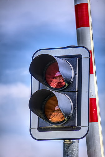 Close-up of red and amber railroad crossing traffic signal