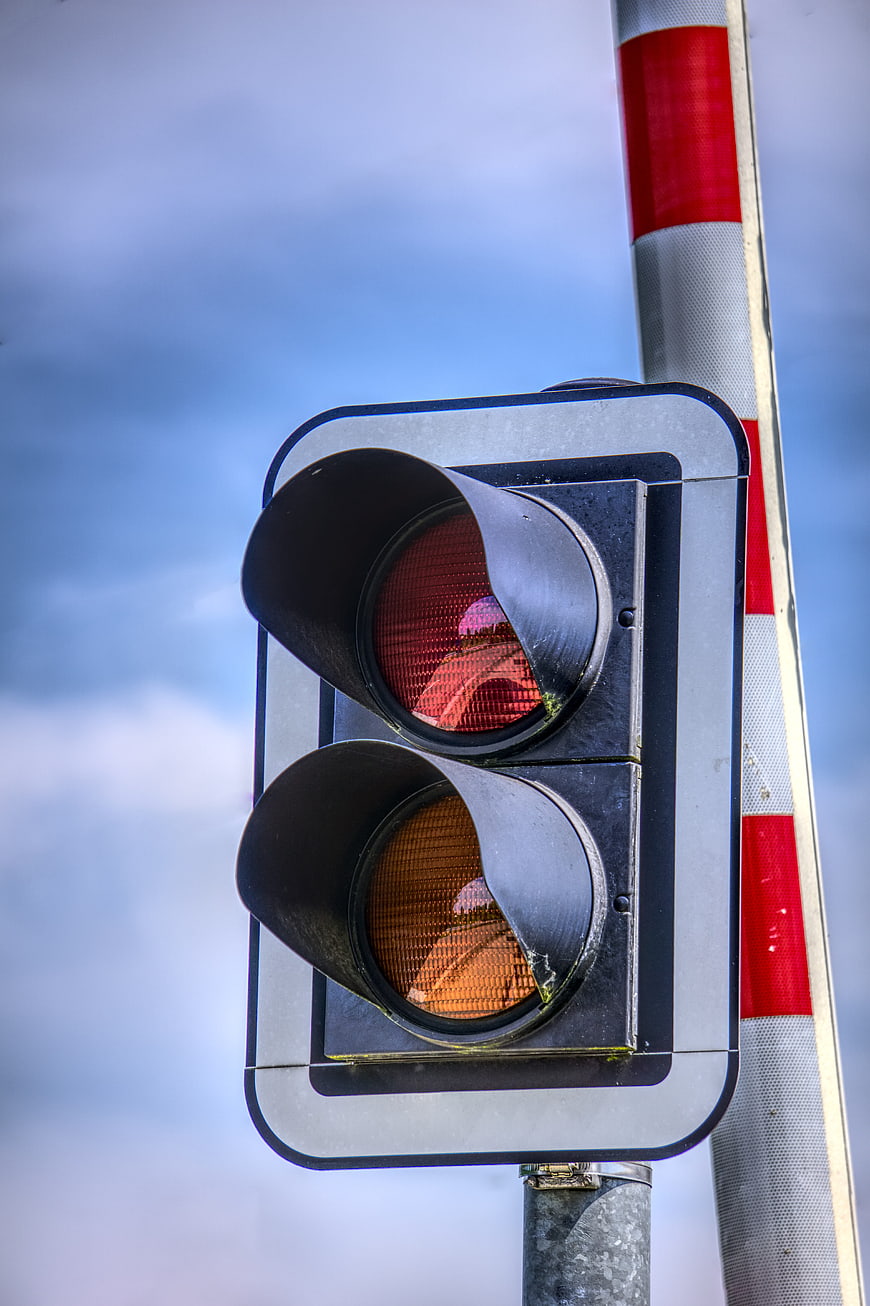 Close-up of red and amber railroad crossing traffic signal