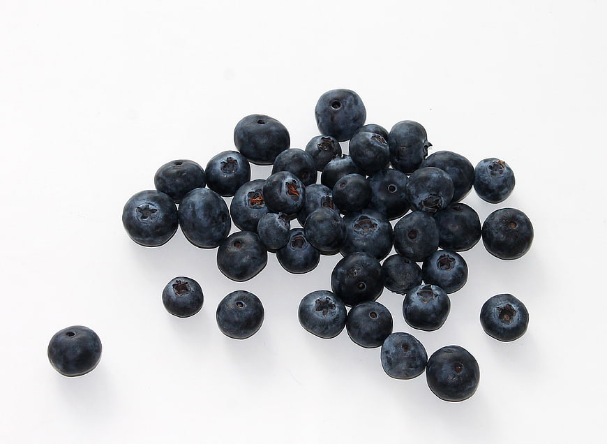 Fresh Blueberries Scattered On White Background