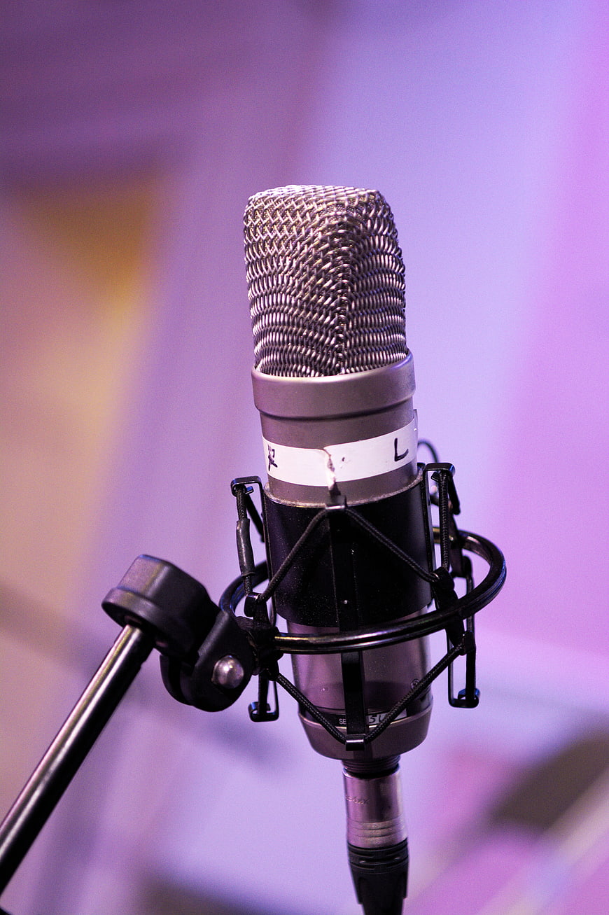 Professional Studio Microphone Close-Up With Purple Background
