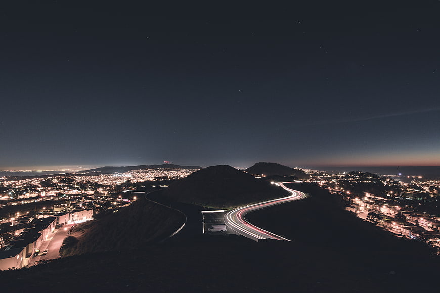 Long Exposure Night Cityscape with Winding Road Light Trails
