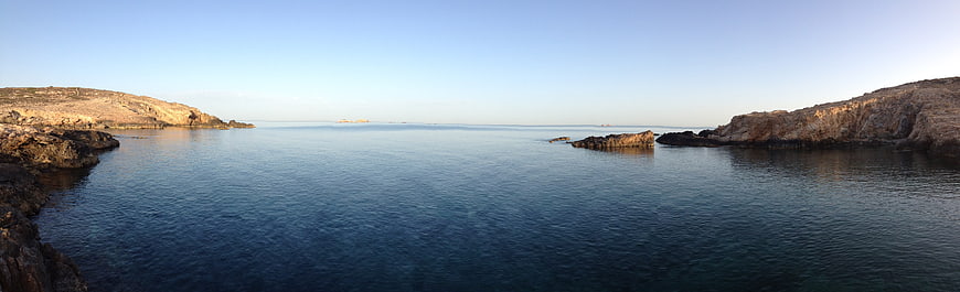 Panoramic view of calm blue sea between rocky cliffs