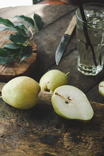 Fresh Green Pears on Rustic Wooden Table with Water