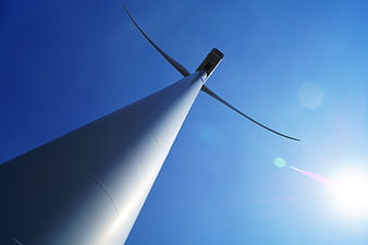 Low angle view of wind turbine against blue sky
