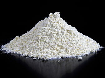 Pile of white flour on black background