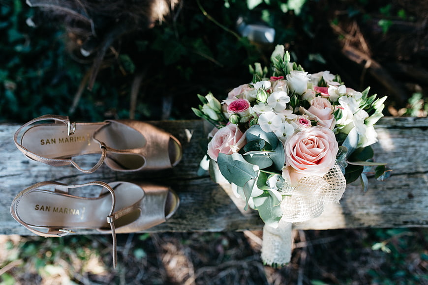 Bridal Shoes and Flower Bouquet on Wooden Bench