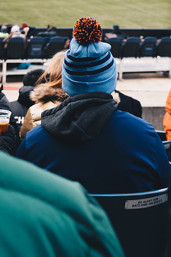 Man in Blue Beanie Watching Baseball Game from Stands