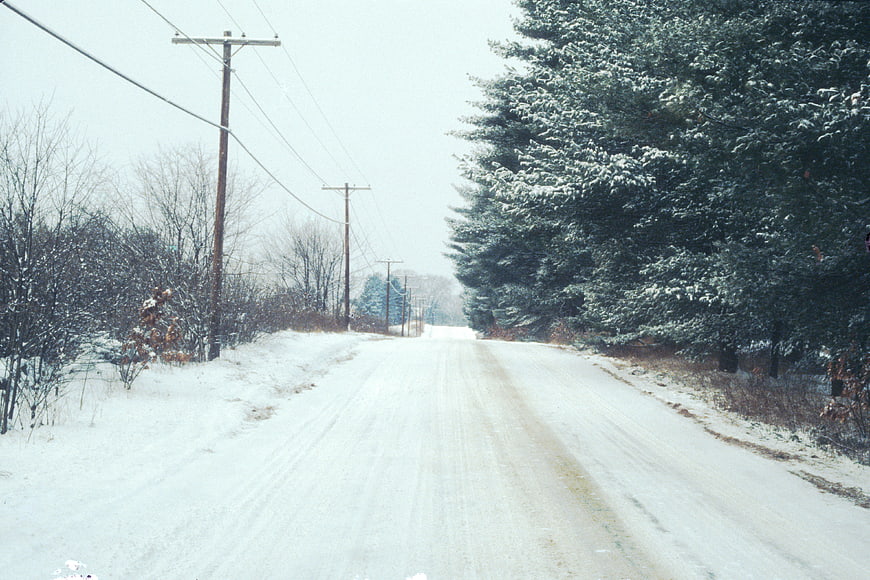 Snowy Rural Road with Evergreen Trees and Power Lines